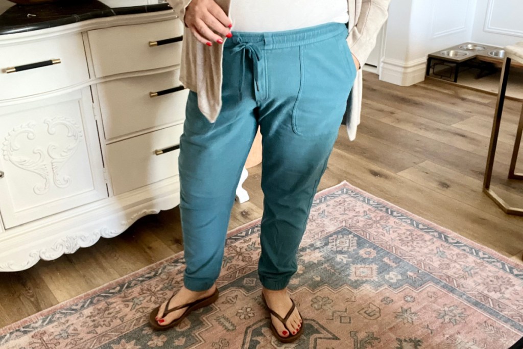 woman wearing teal joggers