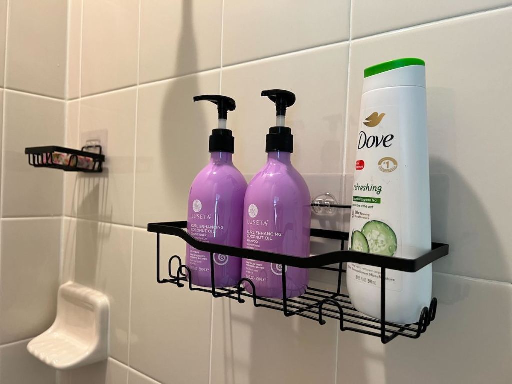bathroom shelf on tile wall with various bottles of beauty products