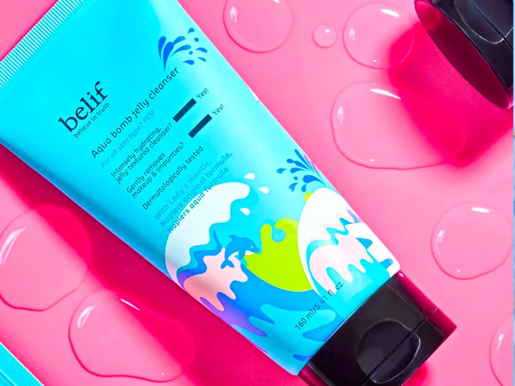 belif aqua bomb cleanser laying on pink table
