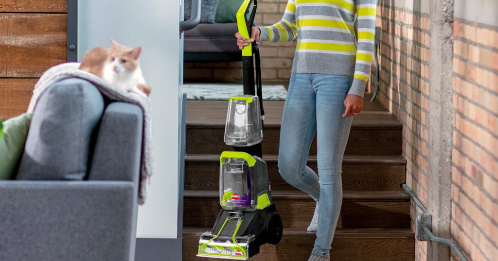 woman carrying carpet cleaner