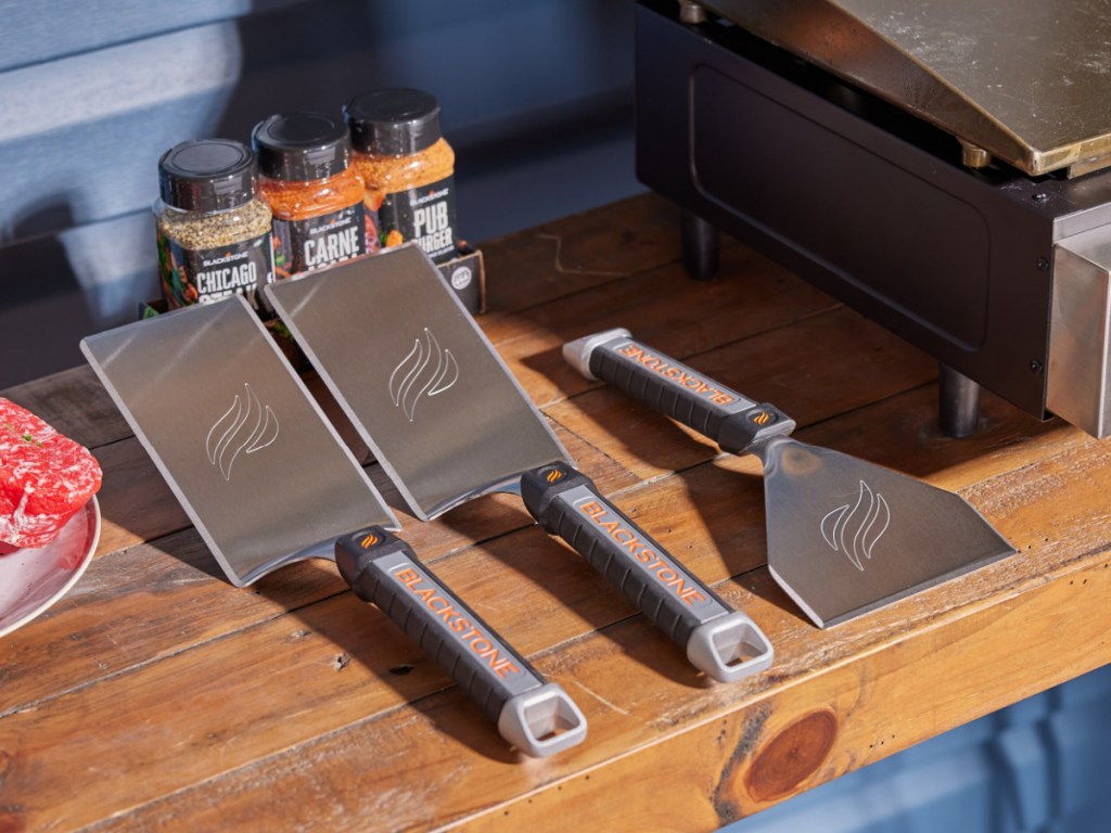 two blackstone spatulas and scraper