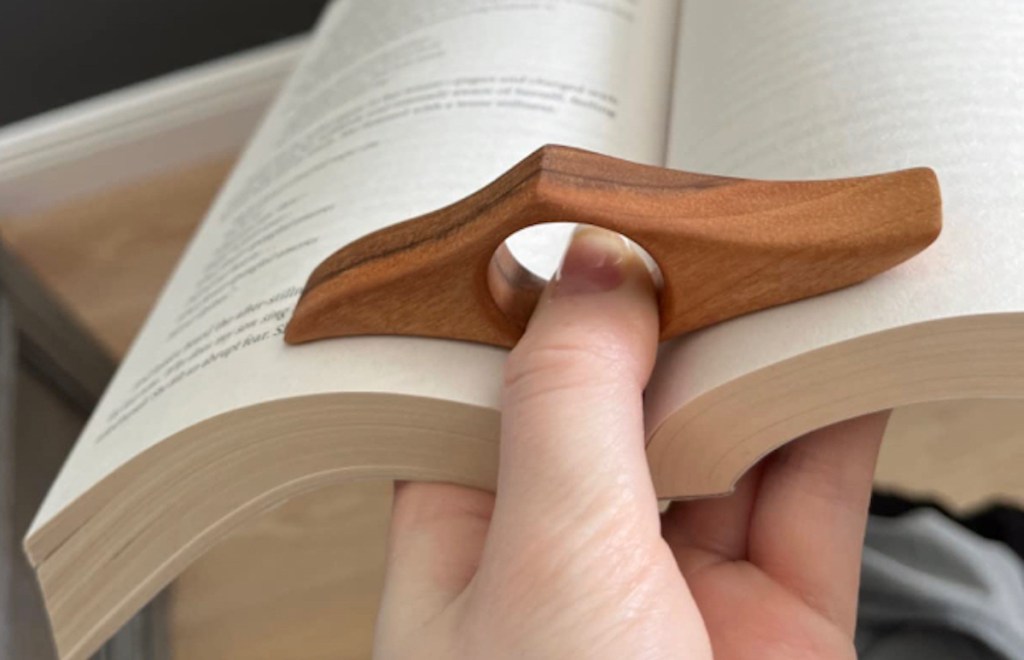 thumb in book page holder in middle of book