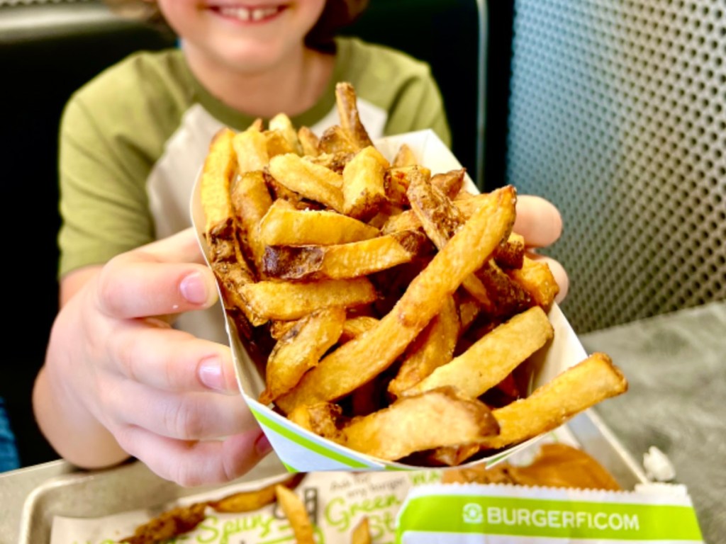 child holding an order of fries