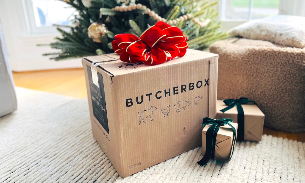 butcherbox and other small gifts with box sitting in front of christmas tree