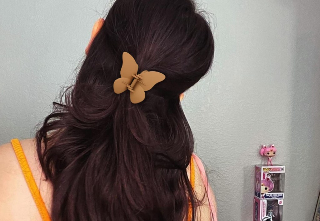  butterfly in brown clip on womans hair