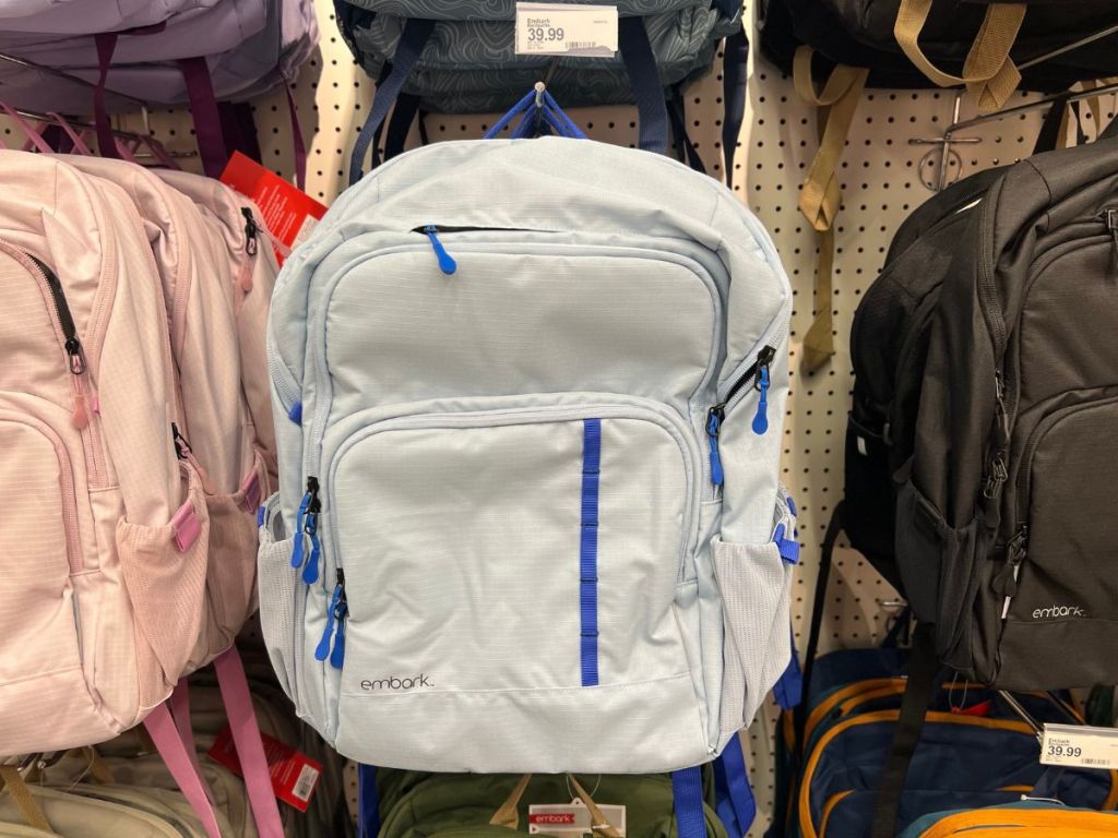 blue embark backpack hanging in store