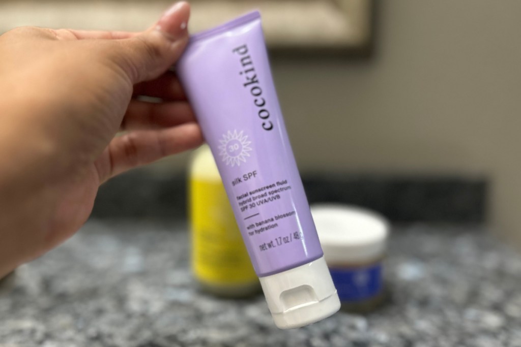 hand holding cocokind skincare product