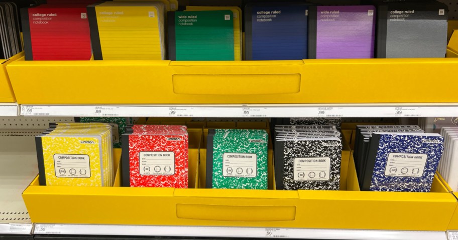composition books in a variety of colors lined up on a target store shelf school supply display