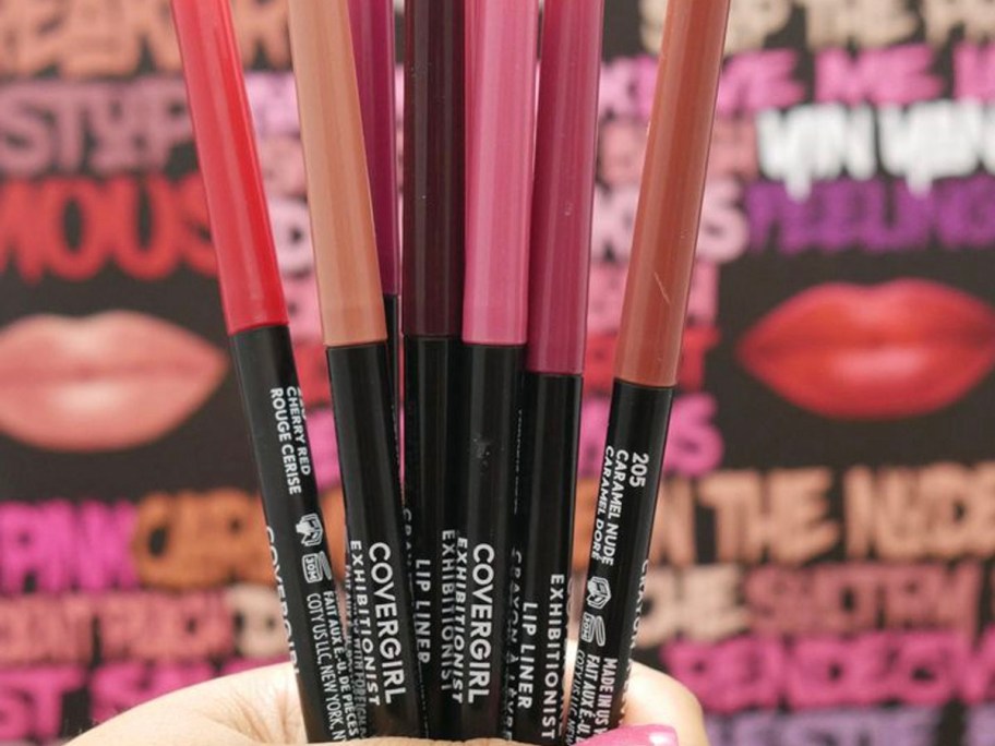 hand holding covergirl eye liners 