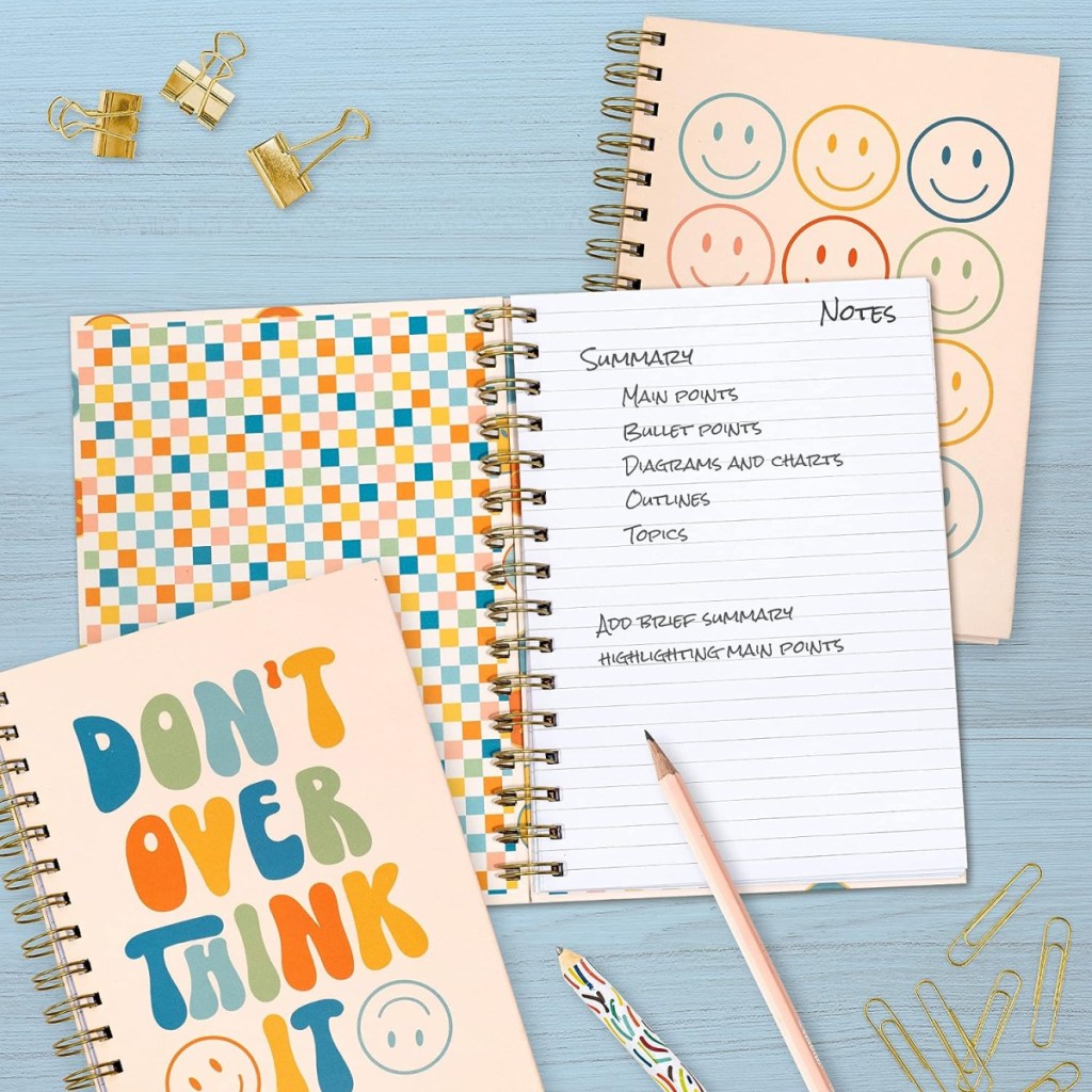 smiley spiral notebooks with writing in them