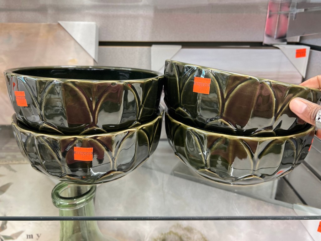 green ceramic bowls stacked on shelf
