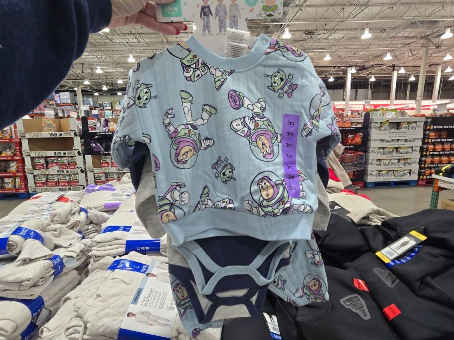person holding buzz lightyear 4 piece clothing set in store