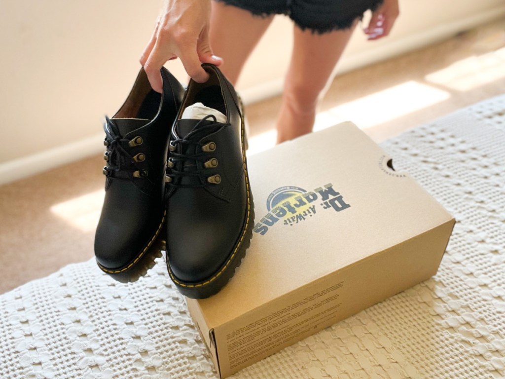 dr martens heeled loafers on shoe box