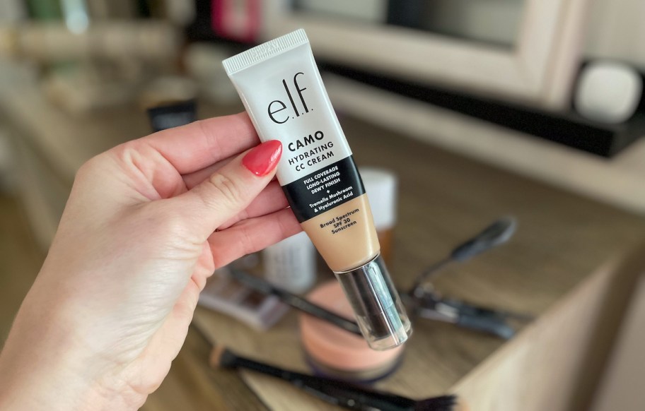 hand holding a tube of elf cosmetics cc cream foundation