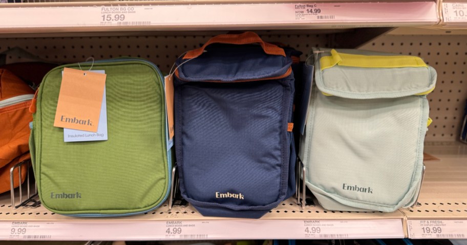 three insulated embark lunch bag totes lined up on a target store shelf