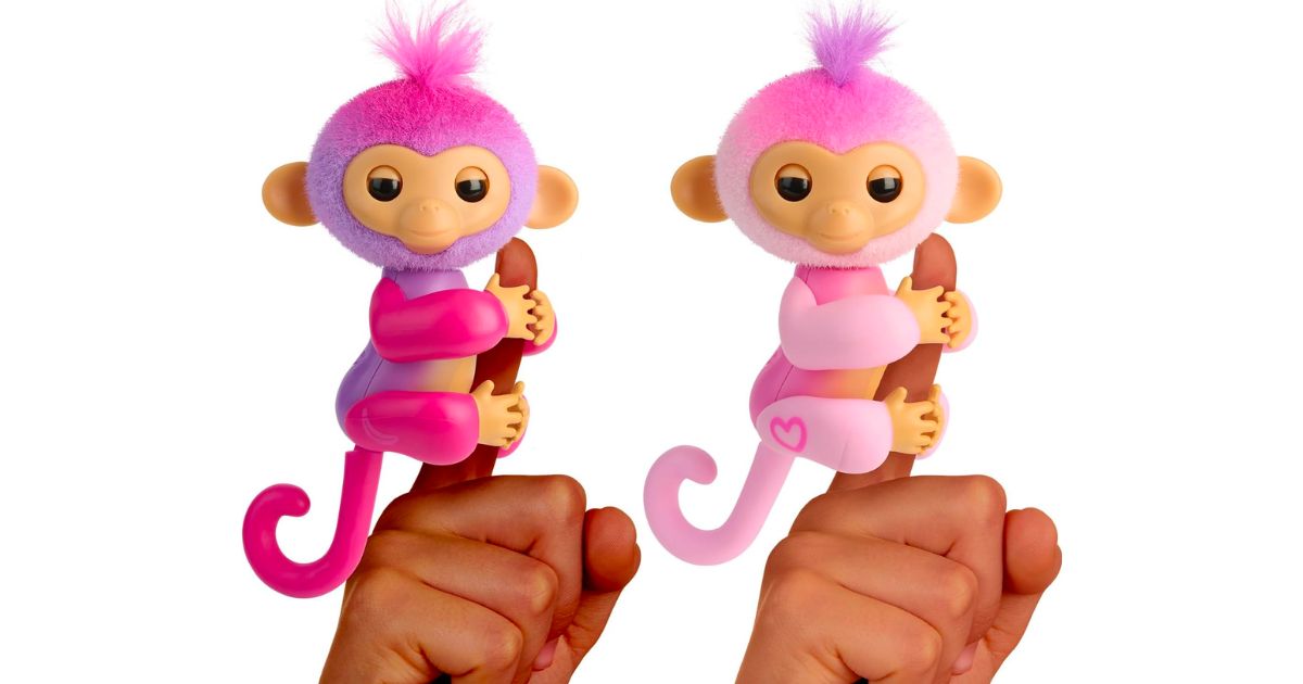 fingerlings charli - purple and harmony - pink on people's index fingers