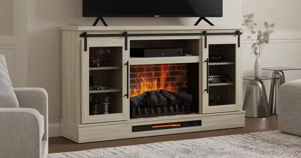 white electric fireplace with tv sitting on top