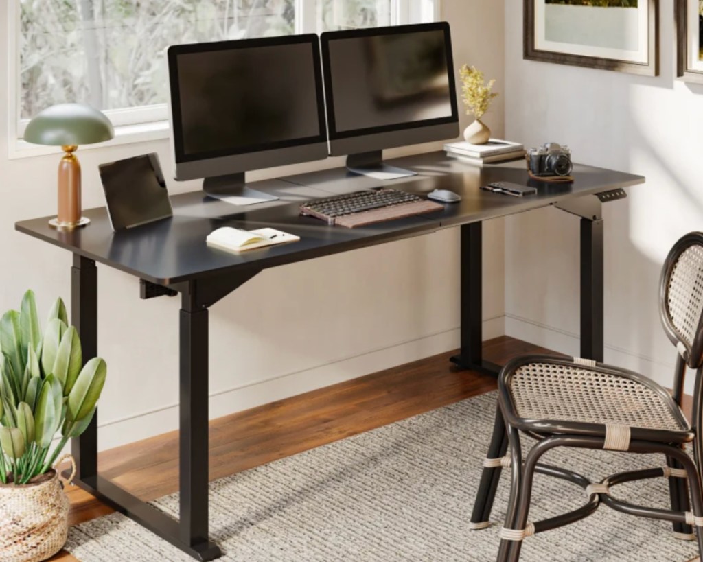 black standing desk with computer 