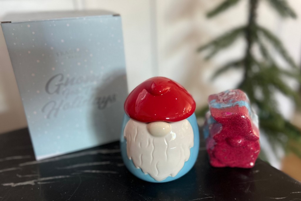 gnome shaped candle and bath bomb near christmas tree