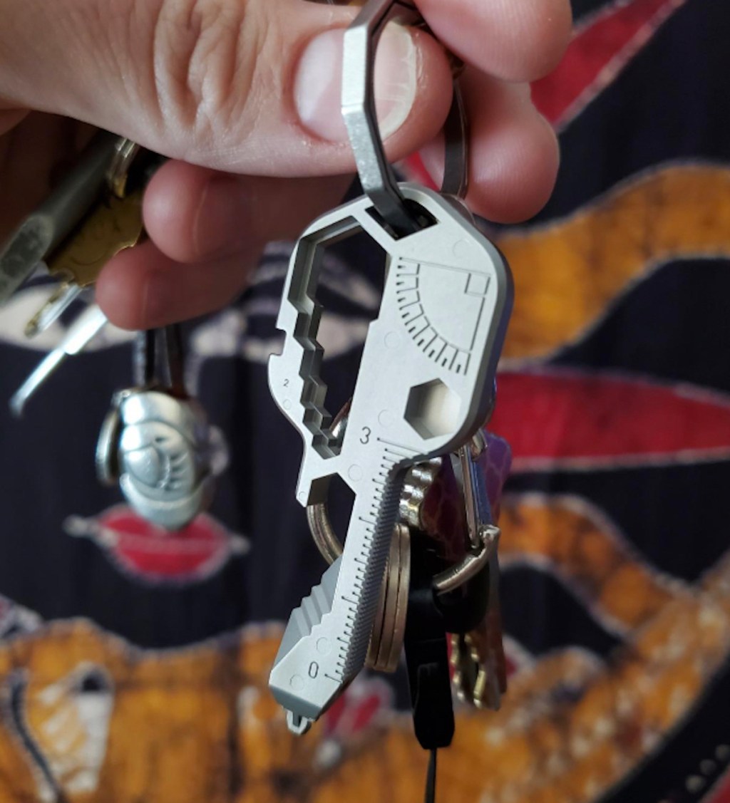 hand holding multi tool key on keychain