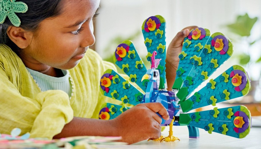 girl playing peacock LEGO