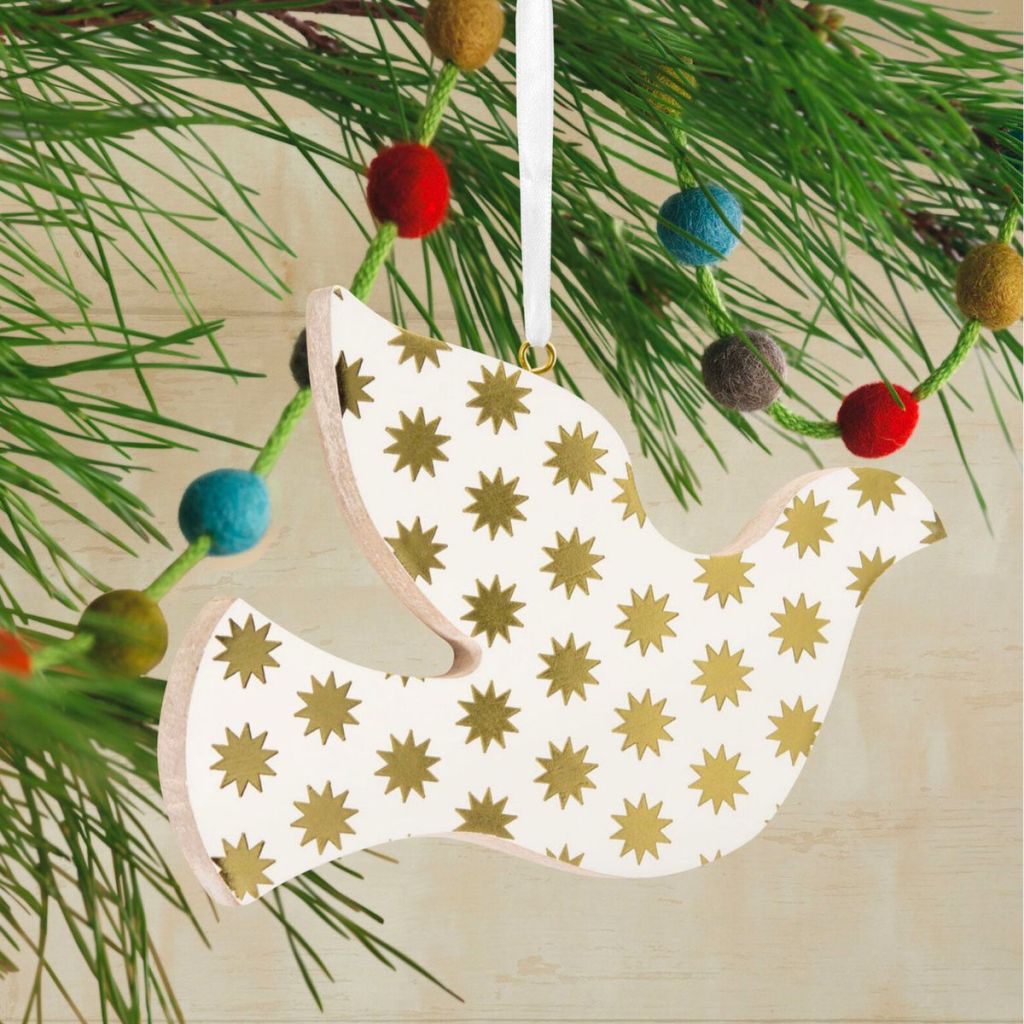 hallmark decor dove ornament hanging on a Christmas tree branch