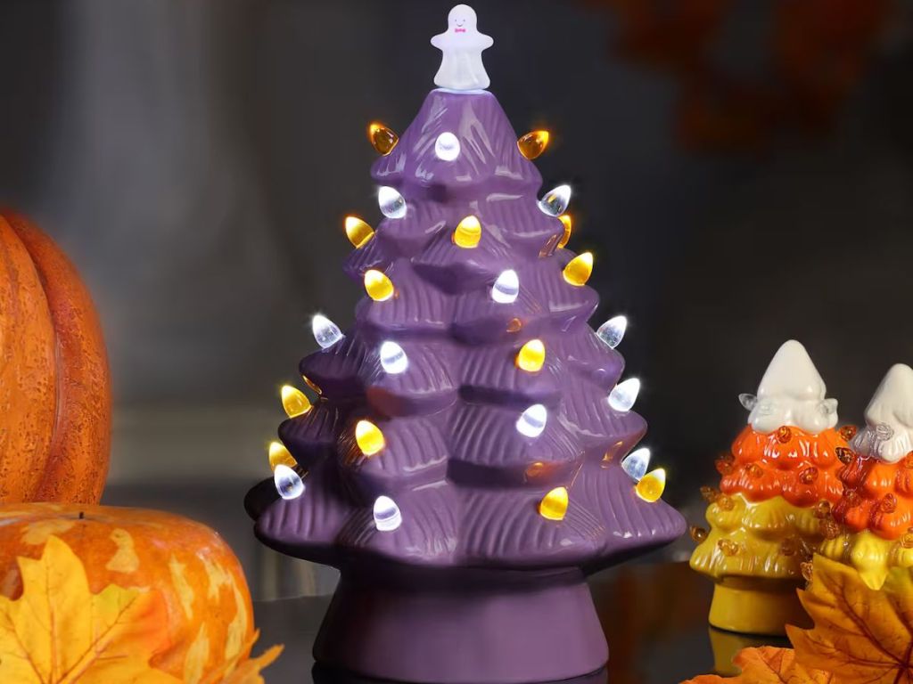 purple ceramic tree with lights and a ghost tree topper
