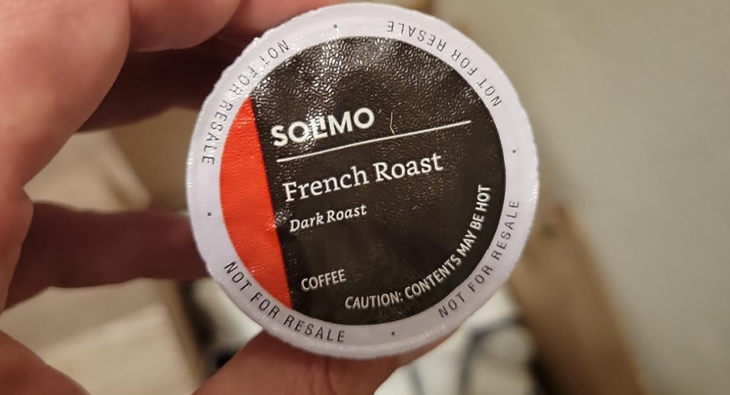 hand holding Solimo French Roast Coffee Pod