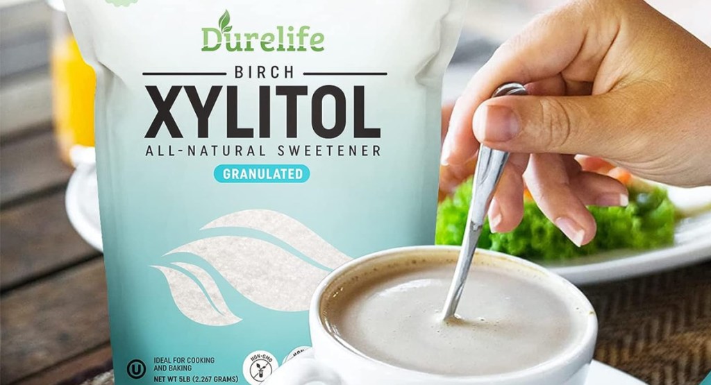 hand mixing coffee with birch xylitol sugar right behind it