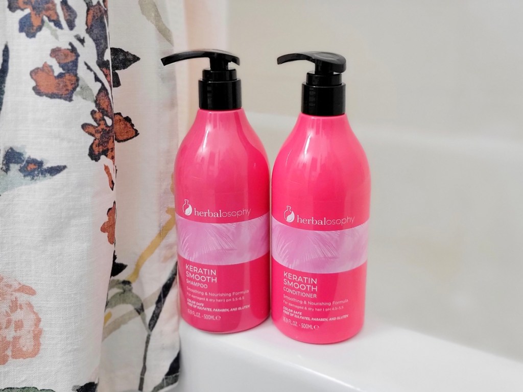 herbalosophy keratin shampoo and conditioner bottles on bathtub