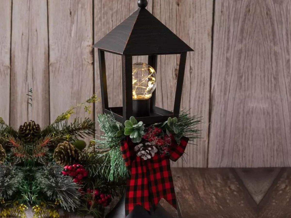 black lantern with Christmas leaves and bow
