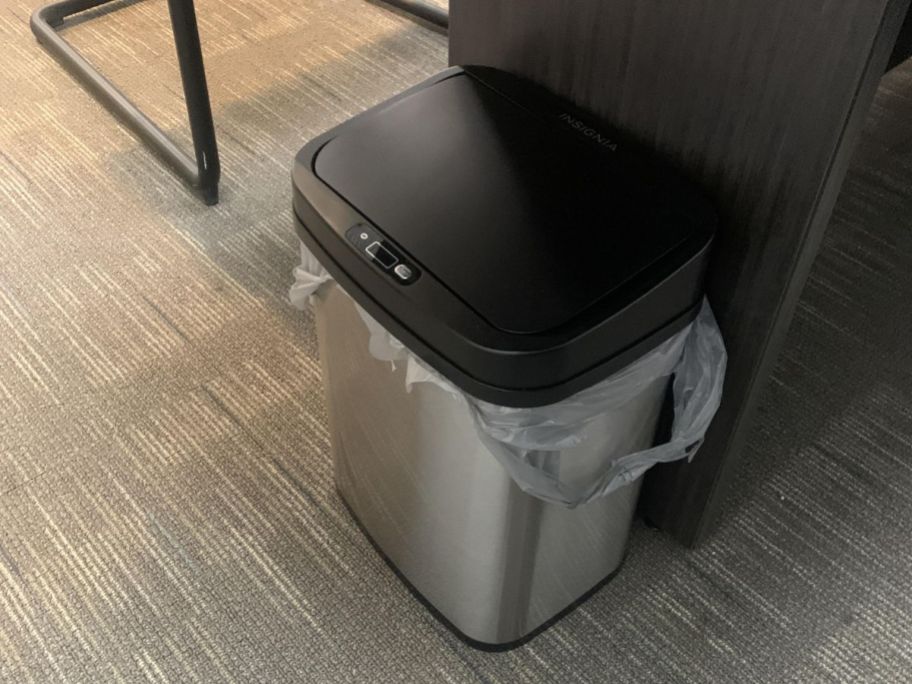 insignia trash can on the floor of an office 
