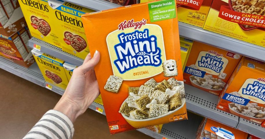 kellogg's frosted mini wheats box in hand in store
