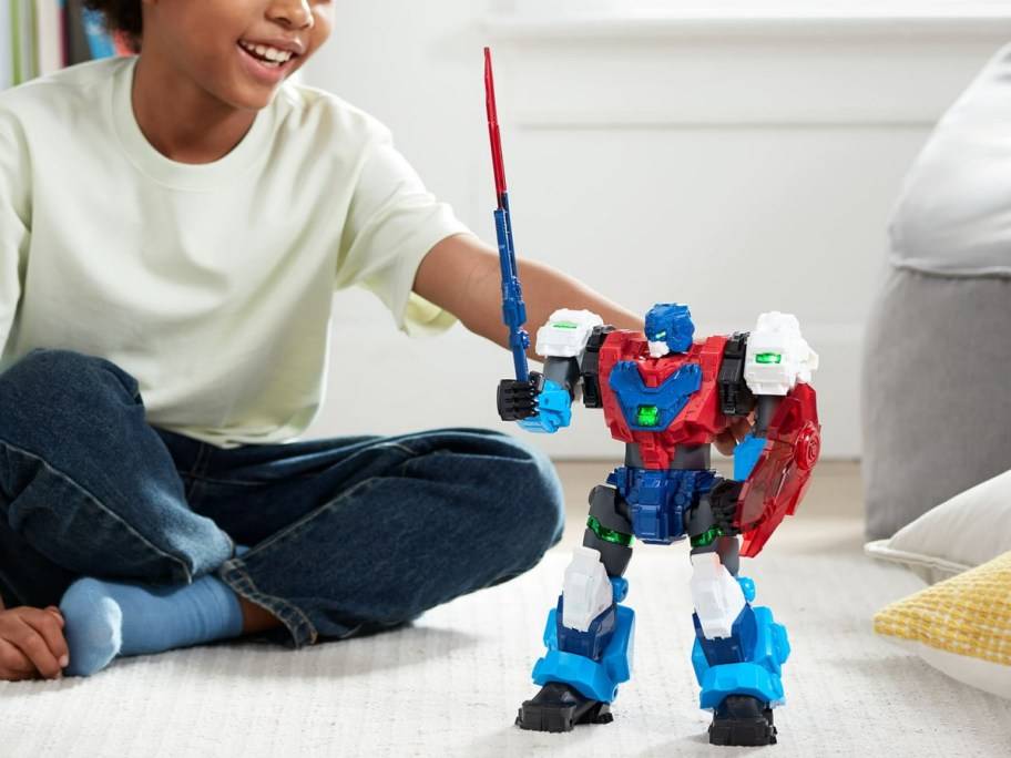 kid playing with action figure on the floor