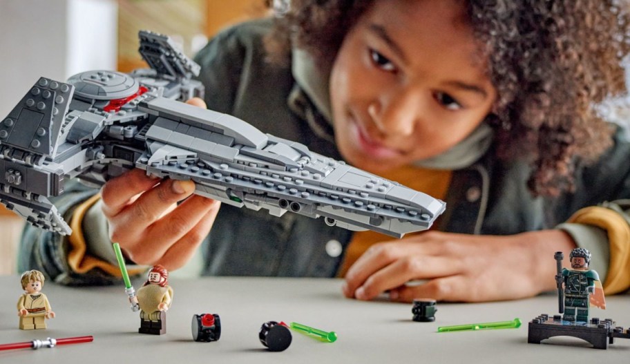 kid playing with starwars spaceship