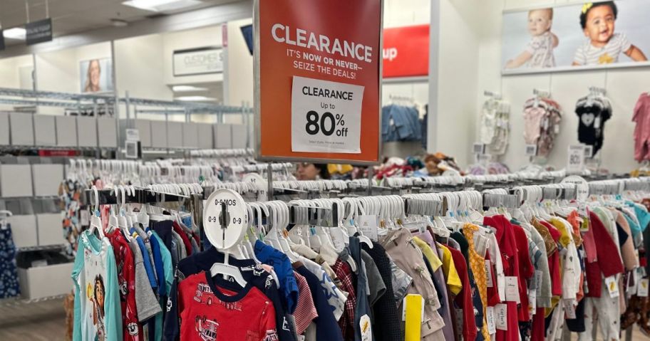 a Kohl's clothing rack with a clearance sign on it