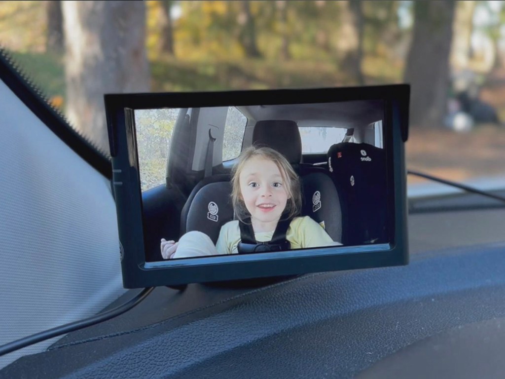 image of girl on baby camera on car dash