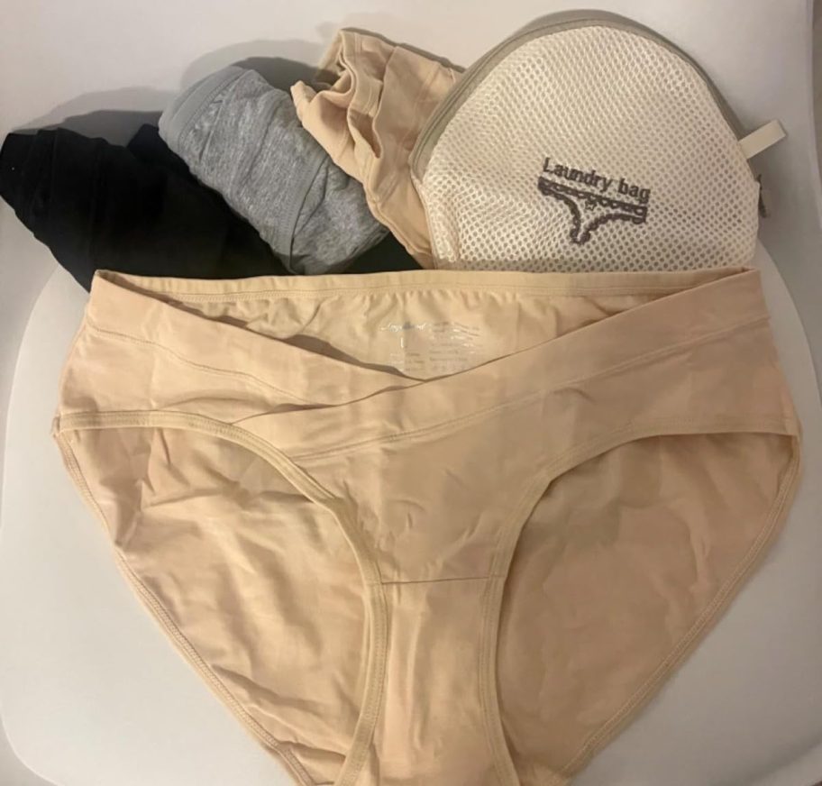 neutral pairs of underwear in pile on white surface