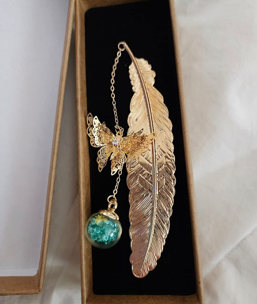gold metal feather bookmark in box