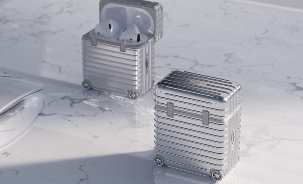 two Airpods cases that look like silver wheeled luggage