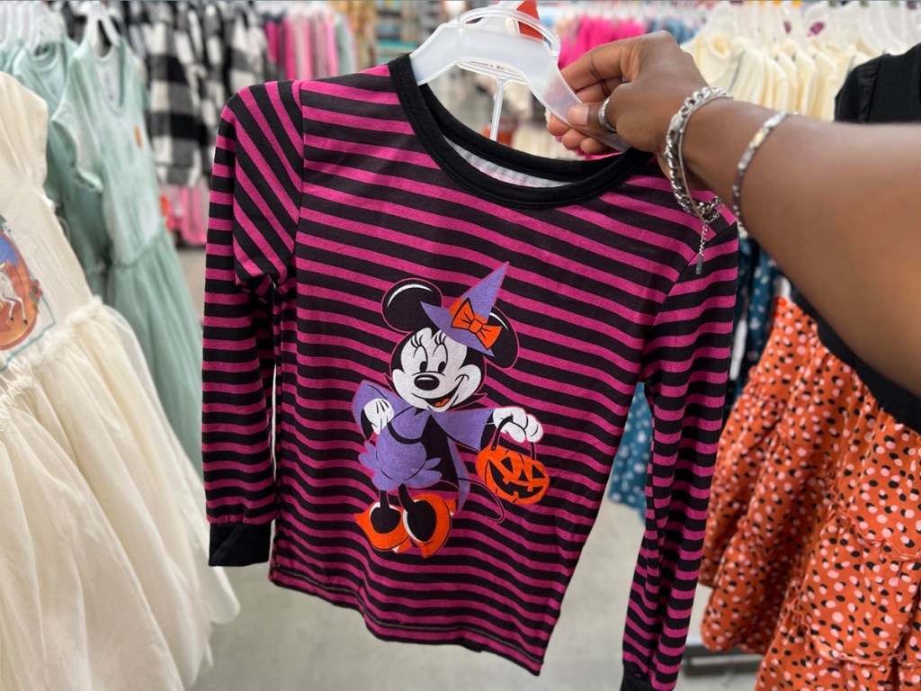 hand holding minnie mouse halloween pajamas