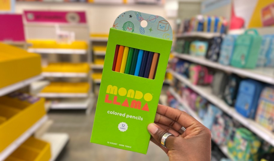 hand holding a pack of mondo llama colored pencils in a target store aisle