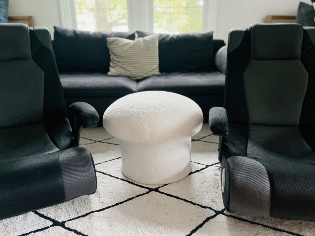 mushroom ottoman in between two gaming chairs