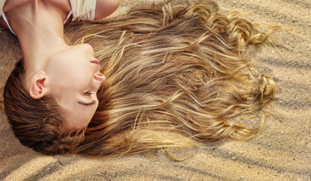 woman with hair in the sand