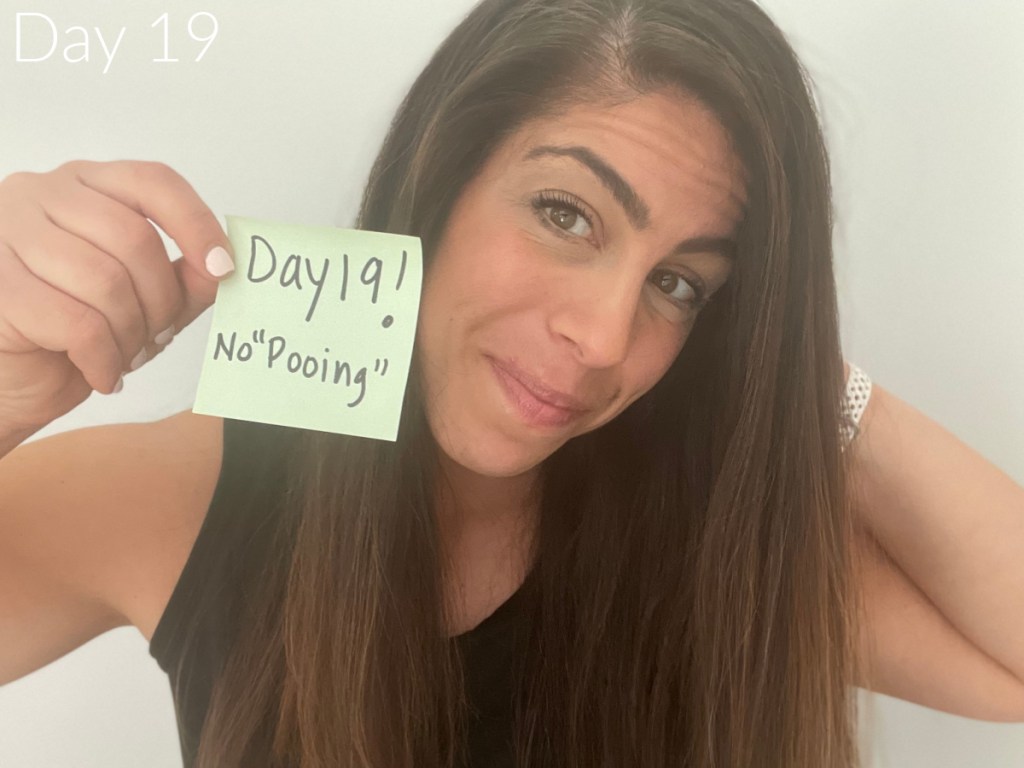 woman holding sticky note during no poo challenge