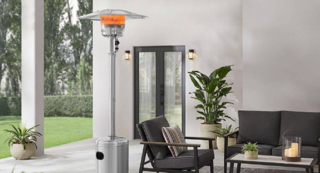 outdoor patio heater displayed with chairs and tables with a plant
