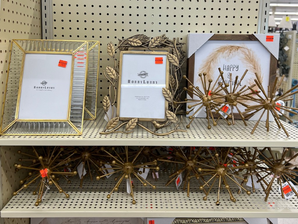 picture frames and decor sitting on shelves in hobby lobby