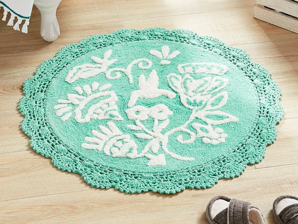 round mint colored floral rug on bathroom floor