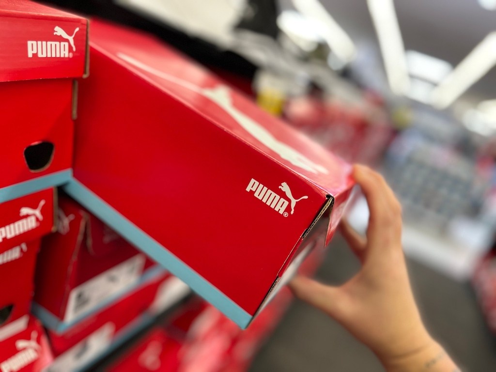 hand pulling Puma shoe box from shelf
