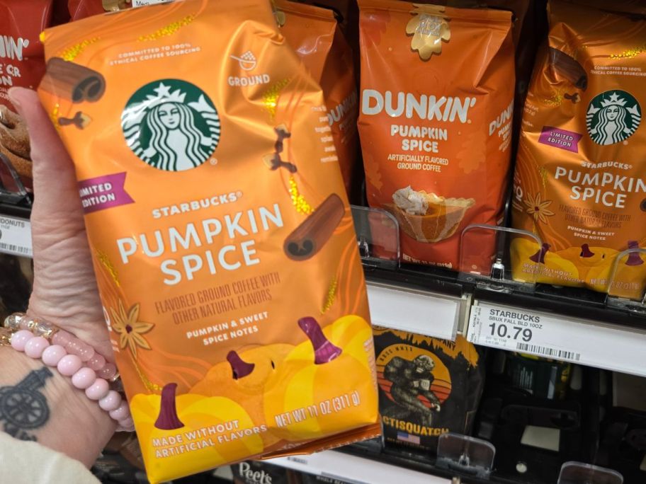 Starbucks Pumpkin Spice Light Roast Ground Coffee 11oz package in hand in store